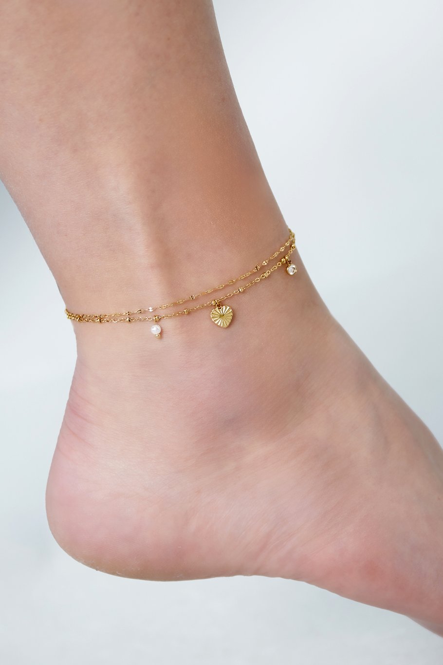 Dubbele hart enkelbandje - goud/zilver
